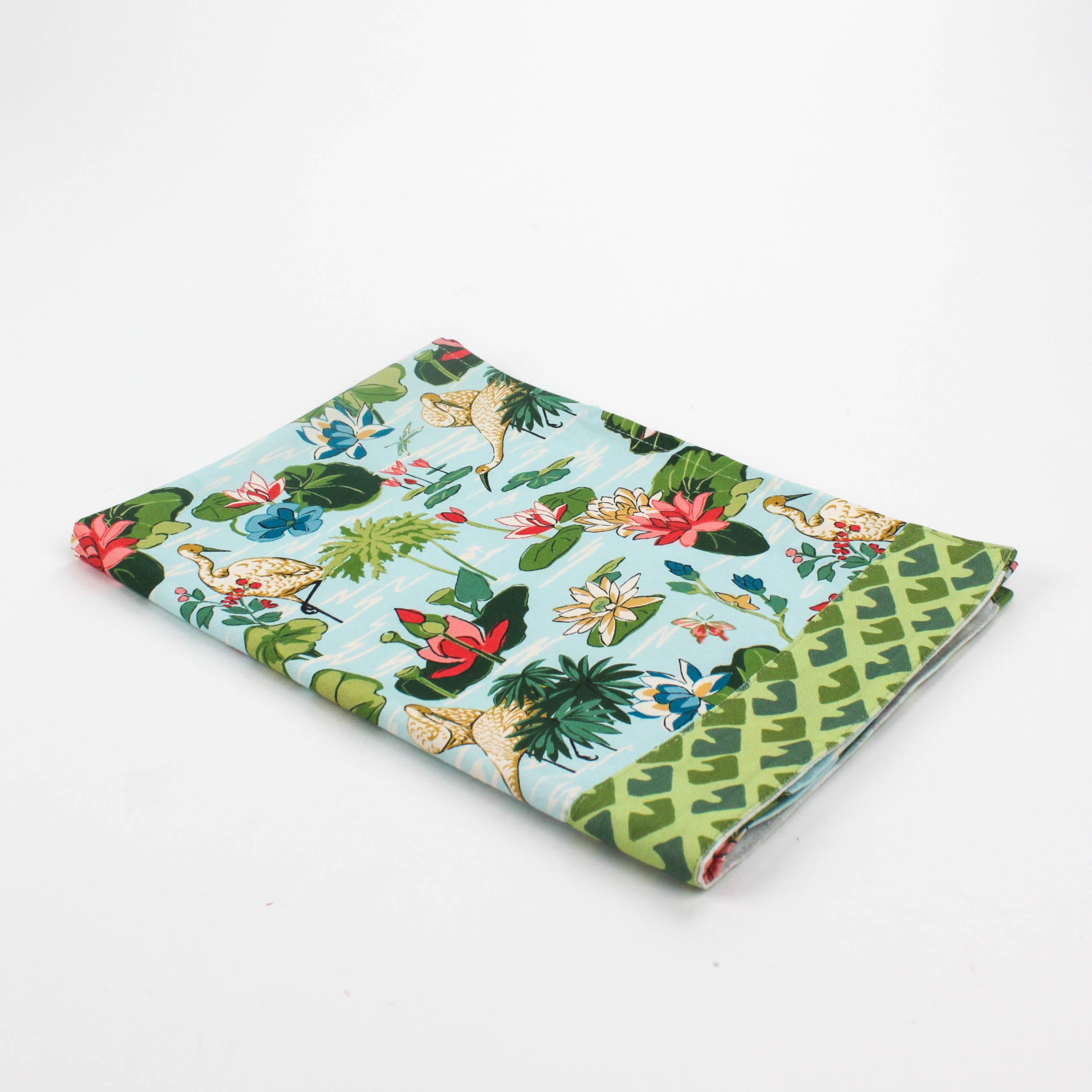 Floral Christmas tea towel featuring water lily and herom motifs
