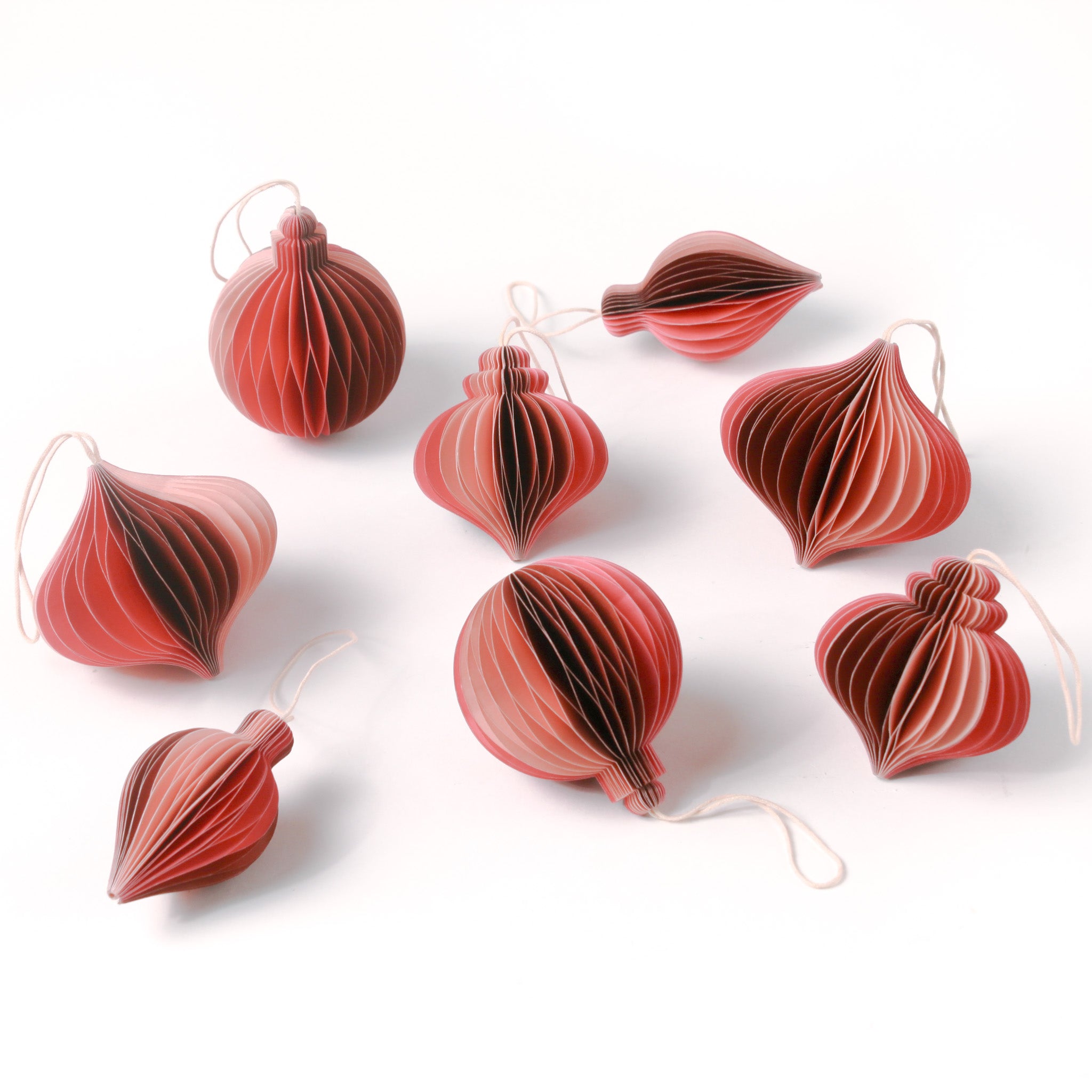 Set of folded paper pink Christmas ornaments in assorted bulb shapes with hanging string