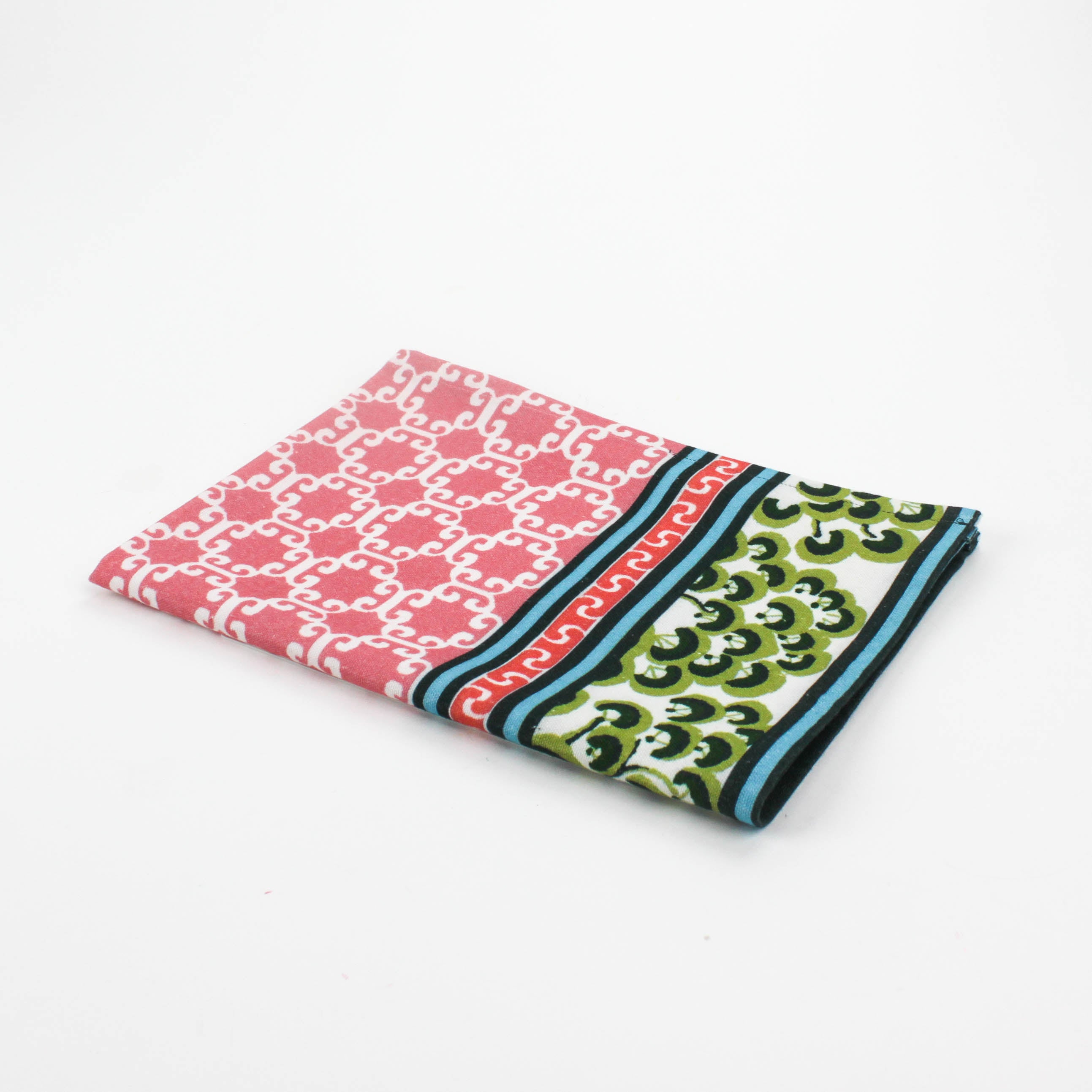 Christmas tea towel featuring a pink lattice pattern with green and white Chinoiserie-inspired borders