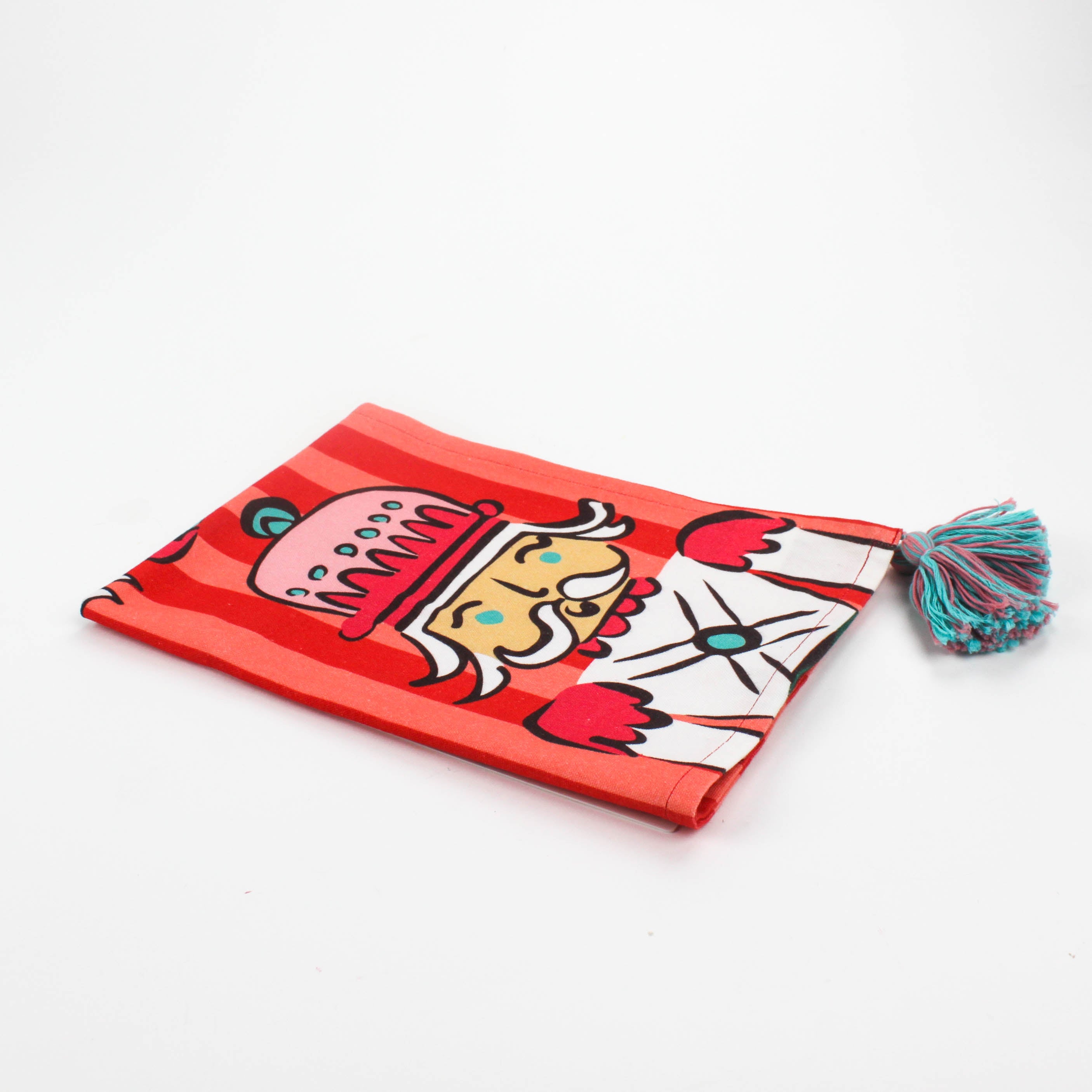 Christmas tea towel featuring colorful nutcracker soldier  with striped background