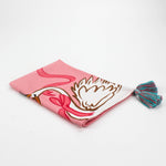 Christmas tea towel designed with a white swan with a golden crown and pink ribbon on a pink background 