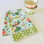 Madcap Cottage folded floral tea towel with two floral bowls in the background