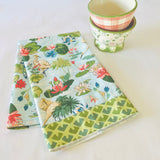 Madcap Cottage folded floral tea towel with two floral bowls in the background
