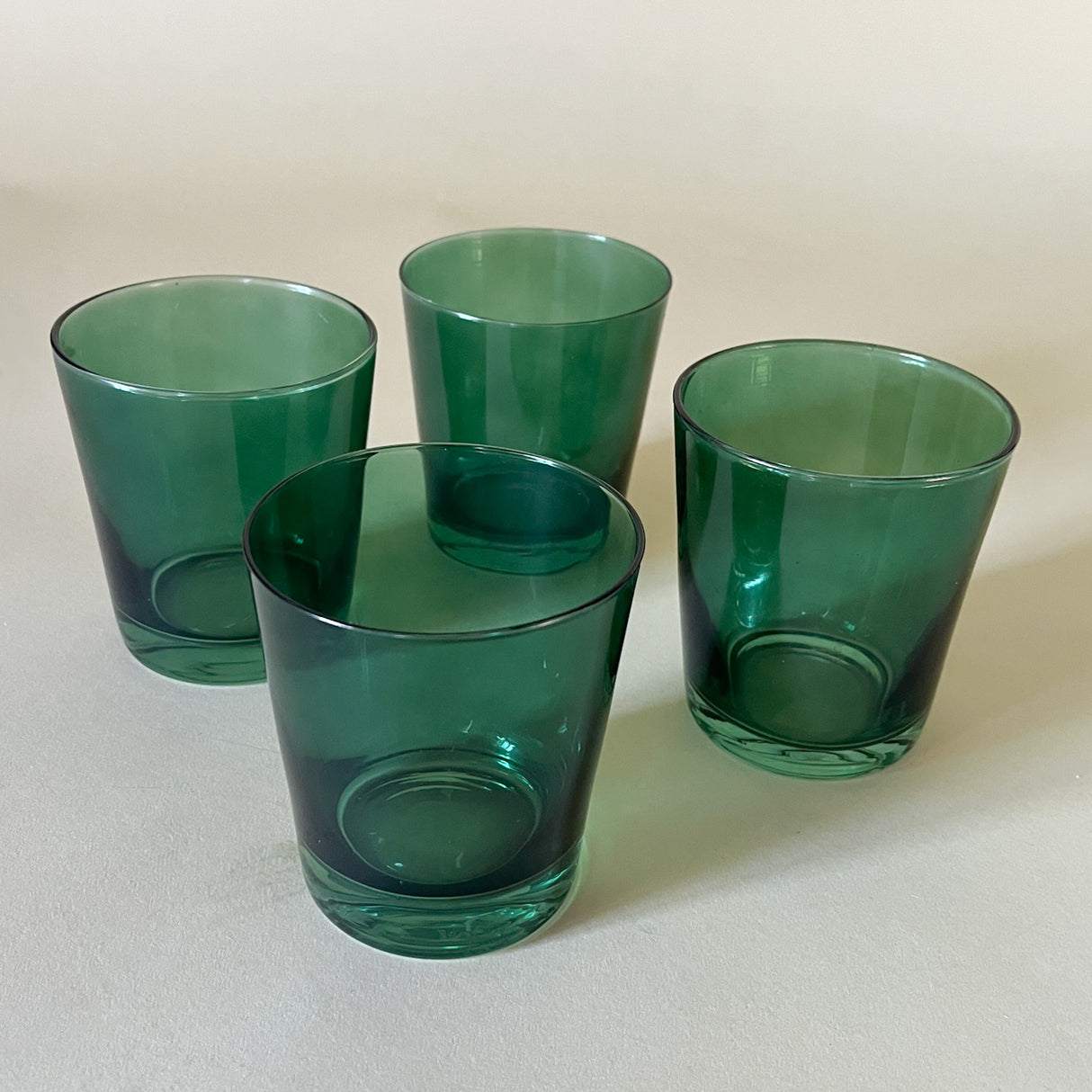 a set of four green colored drinking glasses from madcap cottage