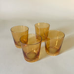a set of four yellow colored drinking glasses from madcap cottage