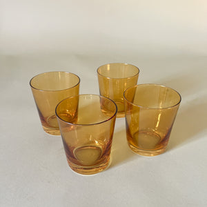 a set of four yellow colored drinking glasses from madcap cottage
