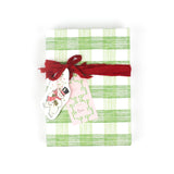 Green gingham gift wrap styled with red ribbon and holiday gift tags.