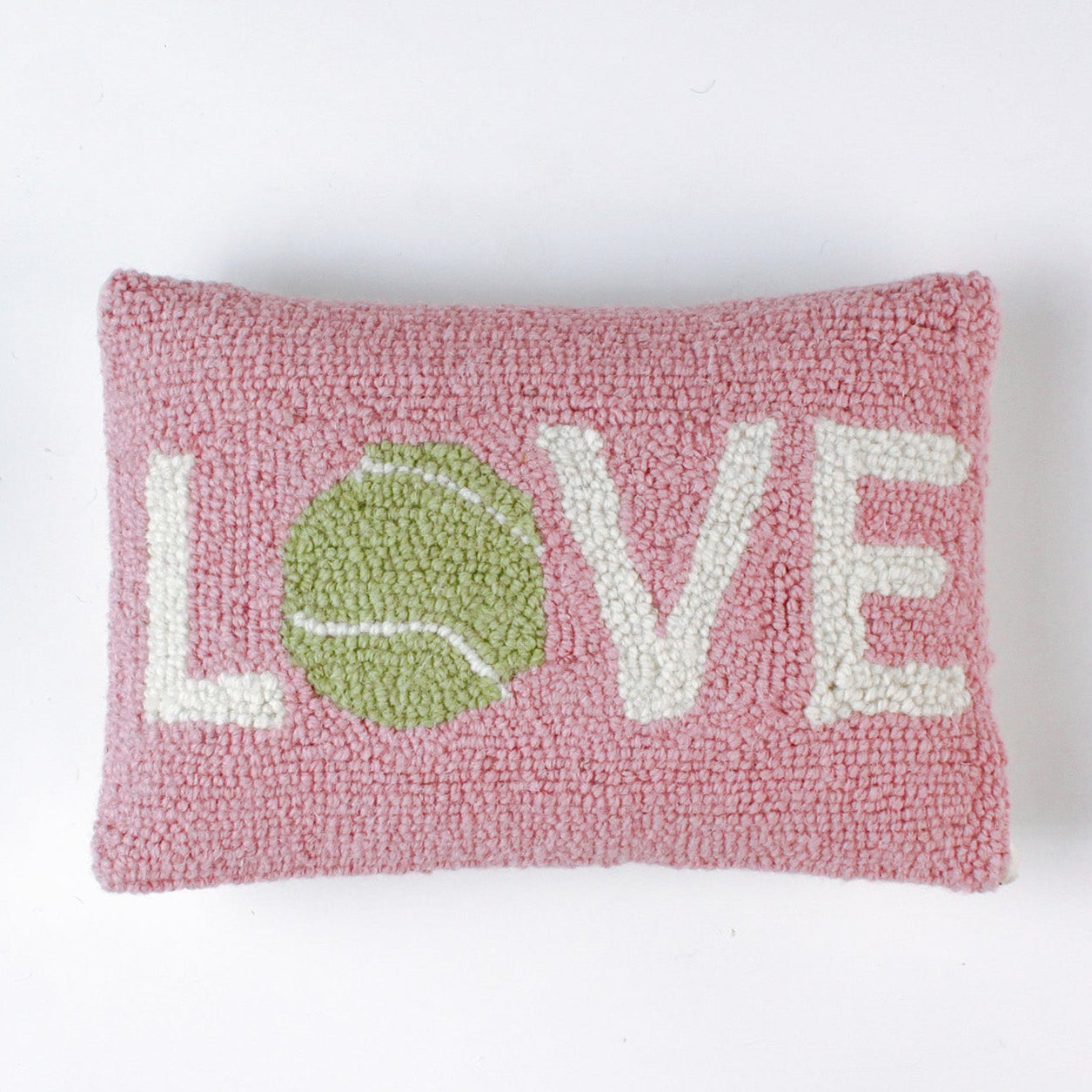 A pink pillow with the word "LOVE," where the "O" is a green tennis ball