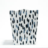 a blue and white wastepaper basket with a brushtroke motif pattern called club house from madcap cottage