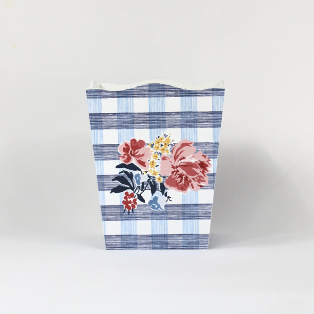 a blue floral wastepaper basket in a gingham pattern with a central floral motif from madcap cottage. 