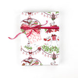 Front view of gift wrapped in mouse-themed holiday wrapping paper with pink ribbon and gift tag.