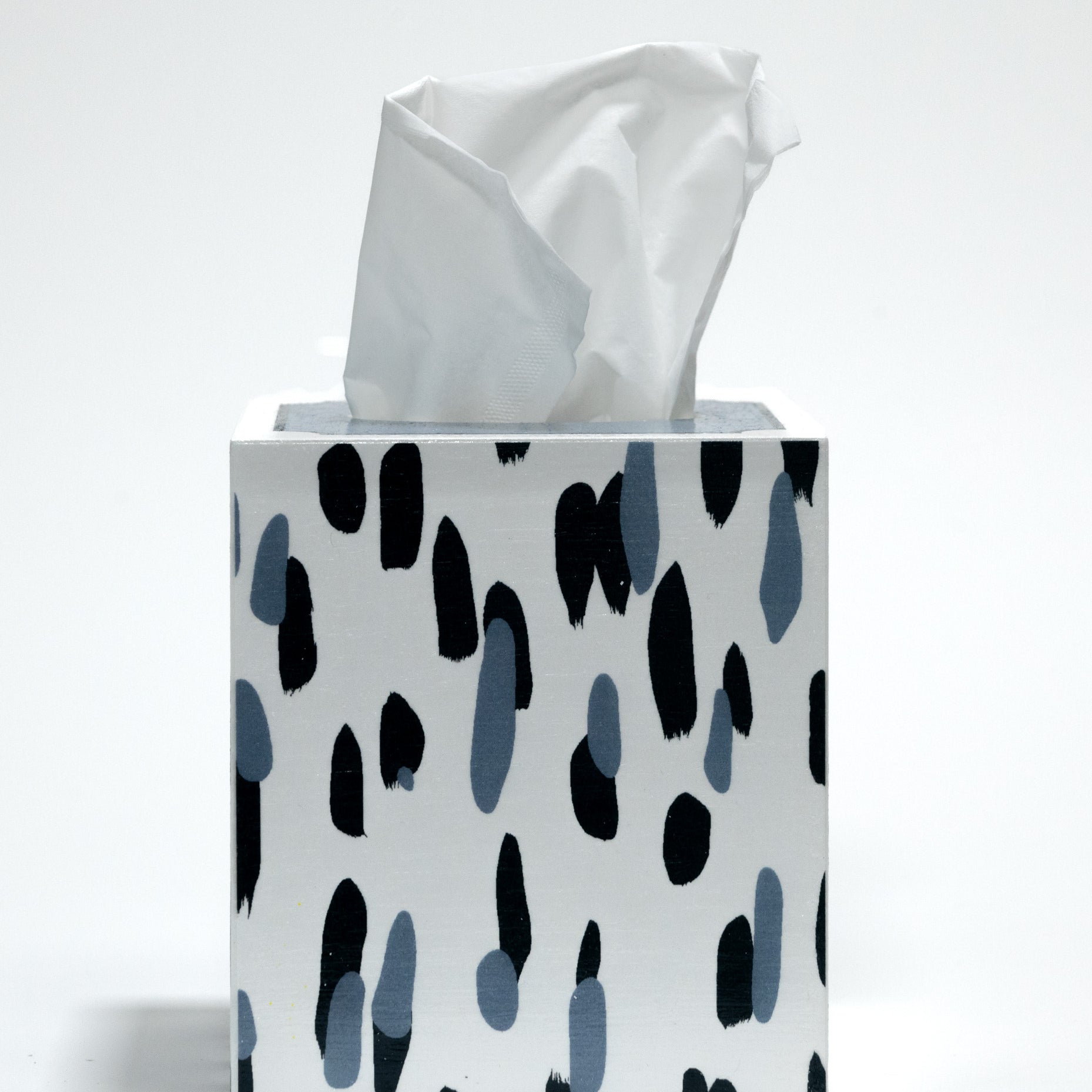 A blue and white tissue box covered with a brushtroke motif pattern called club house by madcap cottage