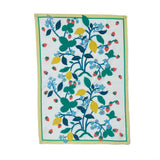 a lemon and strawberry tea towel with blue flowers and a yellow and green border against a white background. 