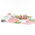 Garden strawberry pink green paper table runner styled with matching mug and bowl.