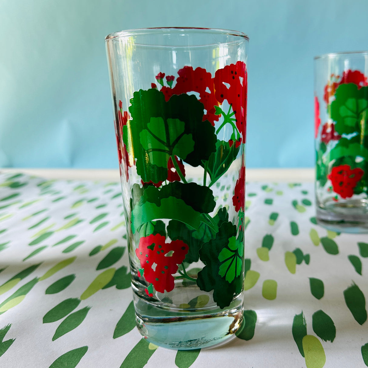 a vintage glasses set of six glasses with red and green geranium motifs.