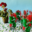 a vintage glasses set of six glasses with red and green geranium motifs.
