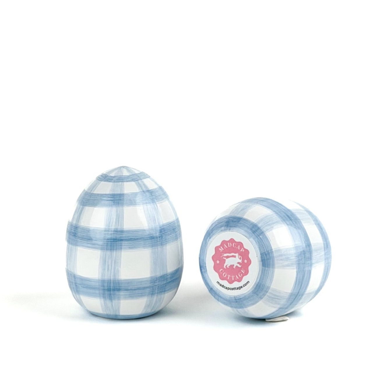 A pair of blue gingham decorative Easter eggs on white background, one egg showing the bottom