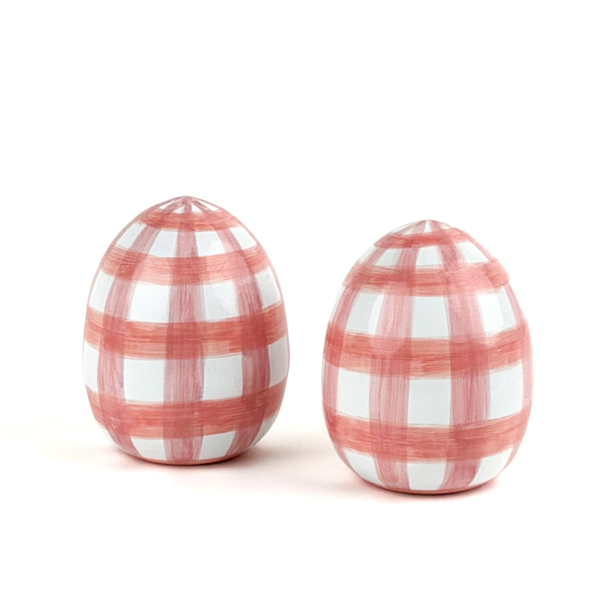a pair of pink gingham decorative Easter eggs on white background