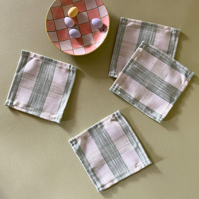 4 Meadow green gingham coctail napkins in the Gin Lane gingham pattern with a dish of candies.