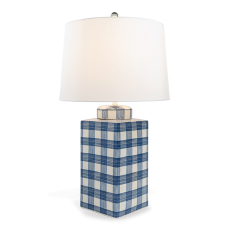 A navy and white gingham porcelain lamp with a white shade