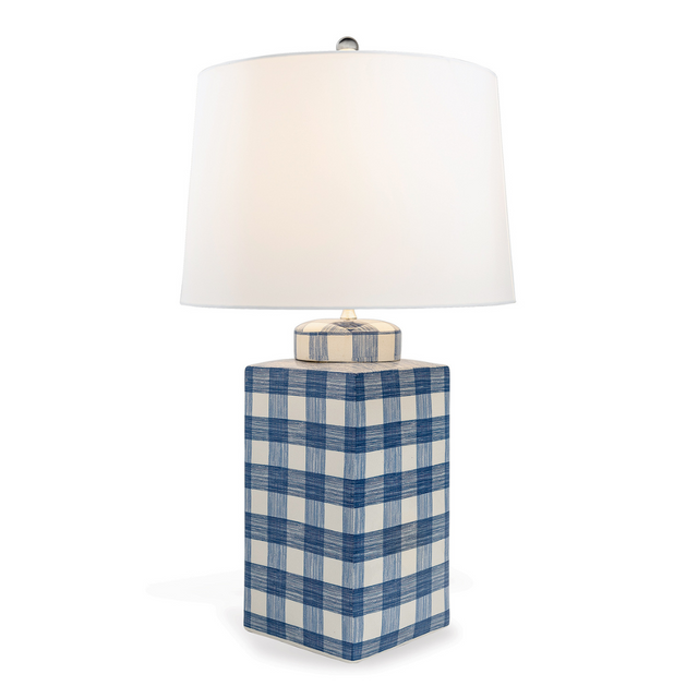 A navy and white gingham porcelain lamp with a white shade