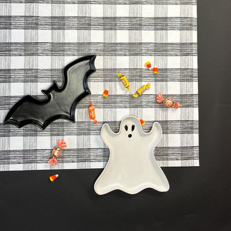 a black  halloween paper table runner in a black and white gingham pattern from madcap cottage with halloween treat on top