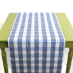 a green table covered by a Gin Lane Blue Gingham Paper Table Runner on a white background