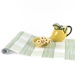 Gingham green paper table runner styled with lemon pitcher and decorative bowl.