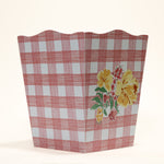 a pink gingham wastepaper basket with a central floral motif from madcap cottage