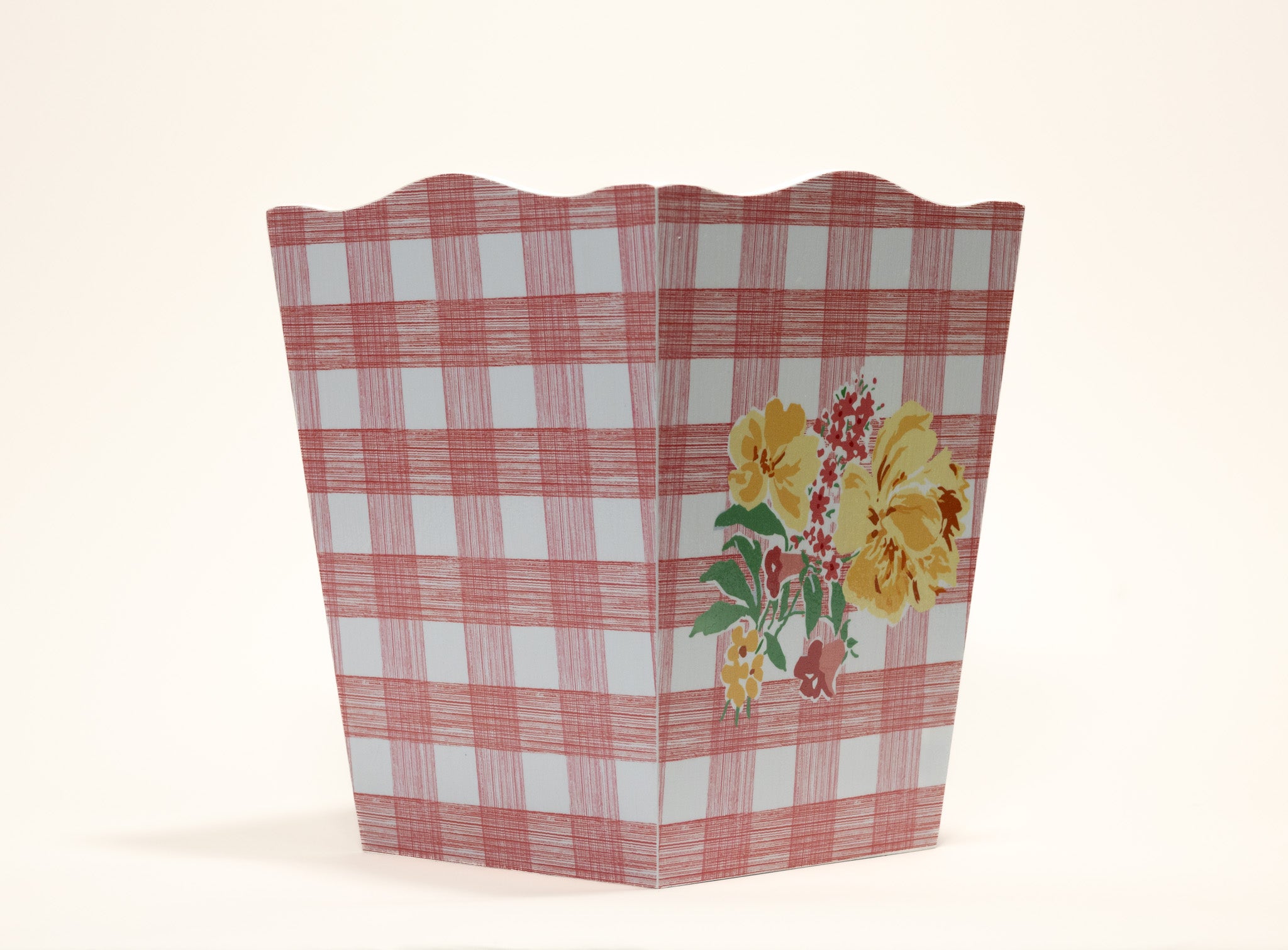 a pink gingham wastepaper basket with a central floral motif from madcap cottage