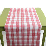 a green table covered with a Gin Lane Pink Gingham Paper Table Runner from Madcap Cottage