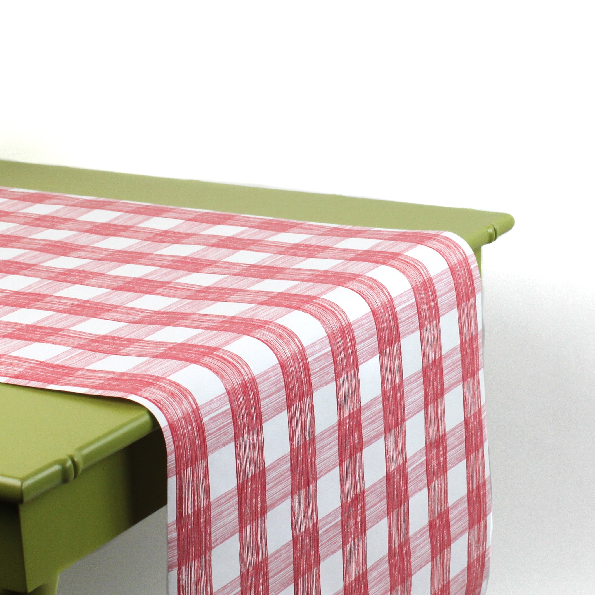 a green table covered with a Gin Lane Pink Gingham Paper Table Runner from Madcap Cottage