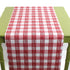 a green table covered by a Gin Lane Red Gingham Paper Table Runner on a white background