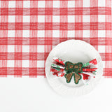a ceramic plate on top of a Gin Lane Red Gingham Paper Table Runner on a white background