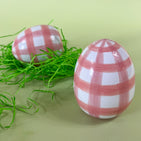 two pink gingham large decorative easter eggs on a green background. 