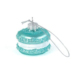Turquoise macaron ornament with a silver chain on a white background
