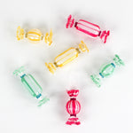 Colorful glass candy ornaments on a white background