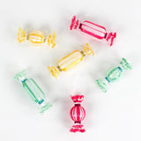 Colorful glass candy ornaments on a white background