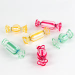 Colorful glass candy ornaments on a white background
