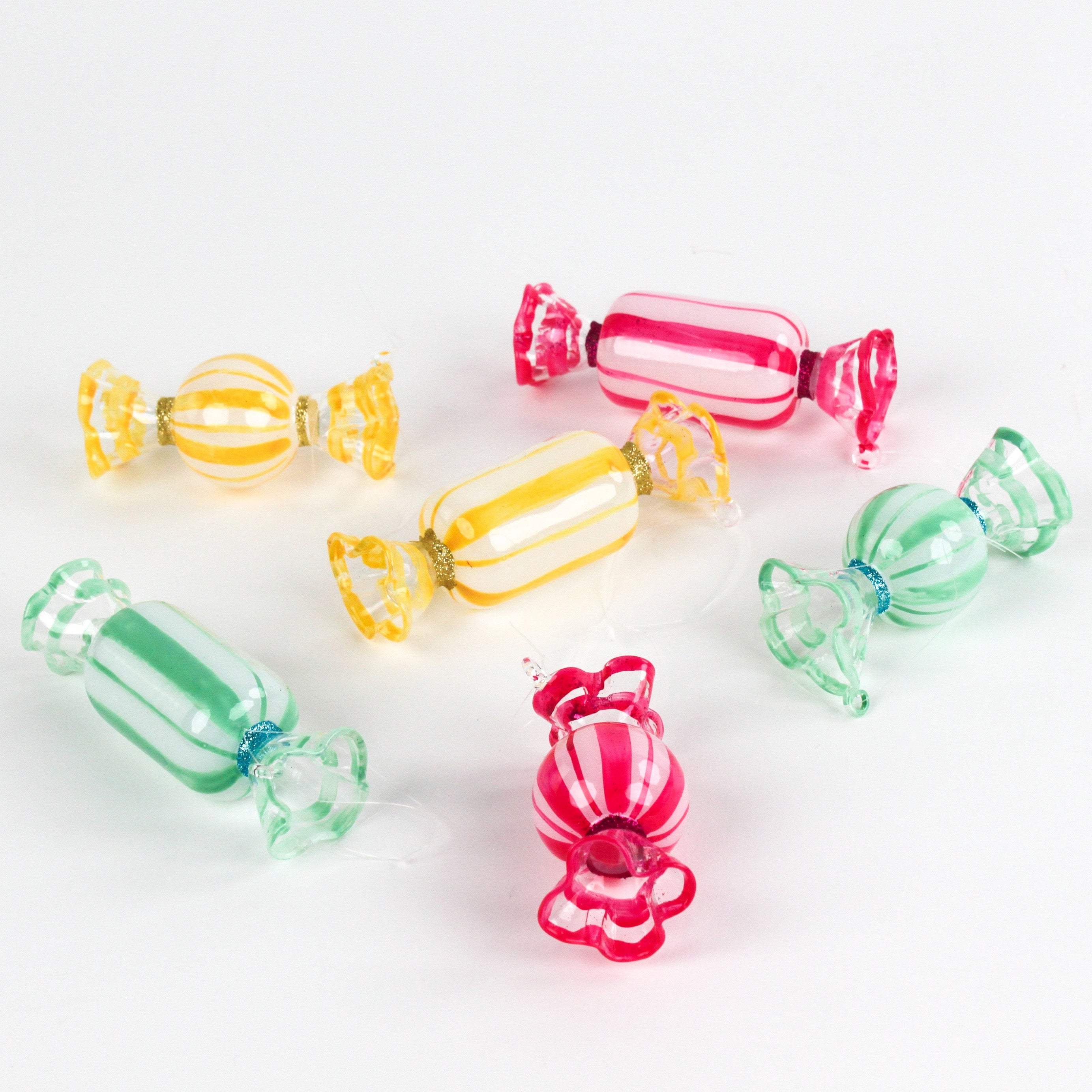 Colorful glass candy ornaments on a white background