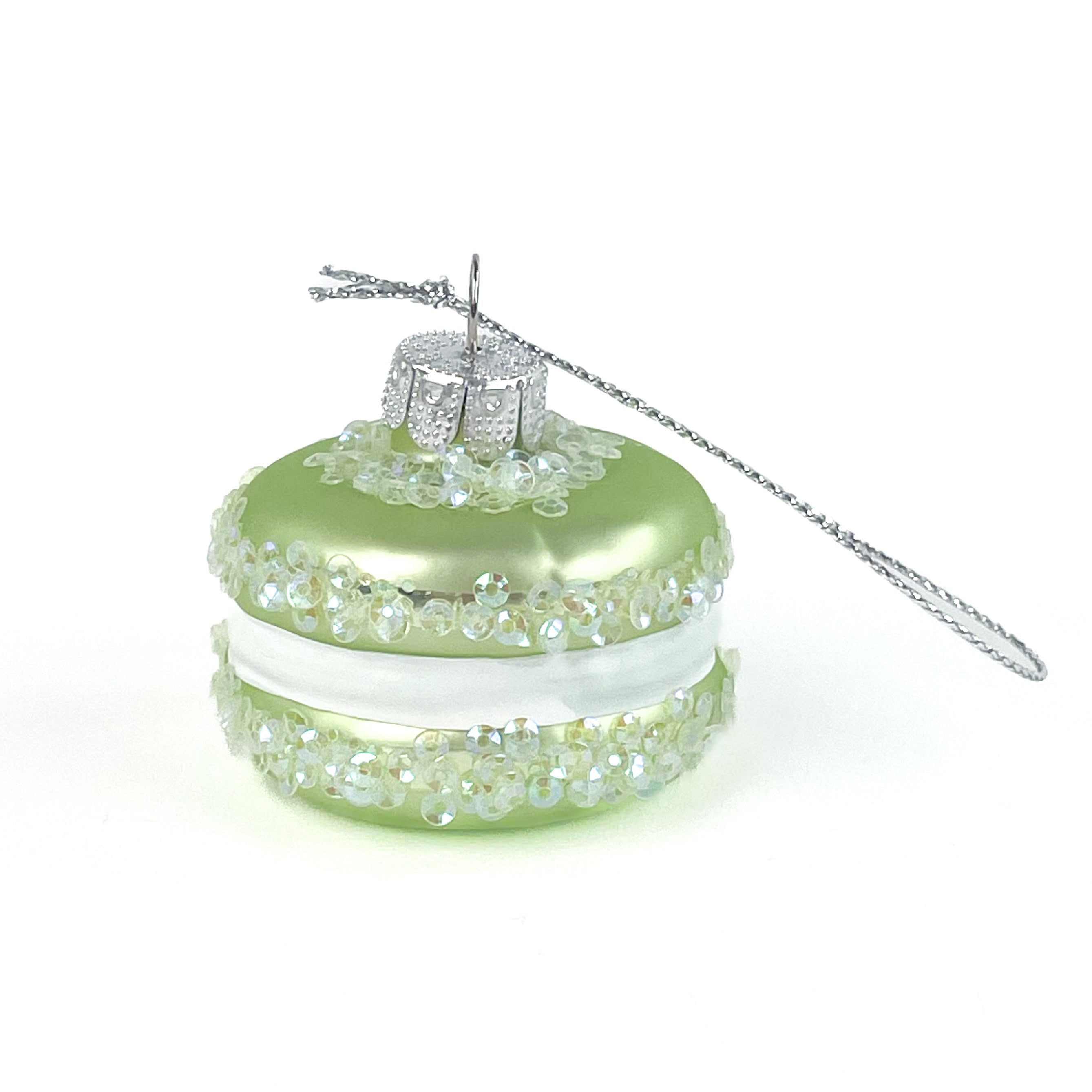 green macaron ornament on a white backround. 