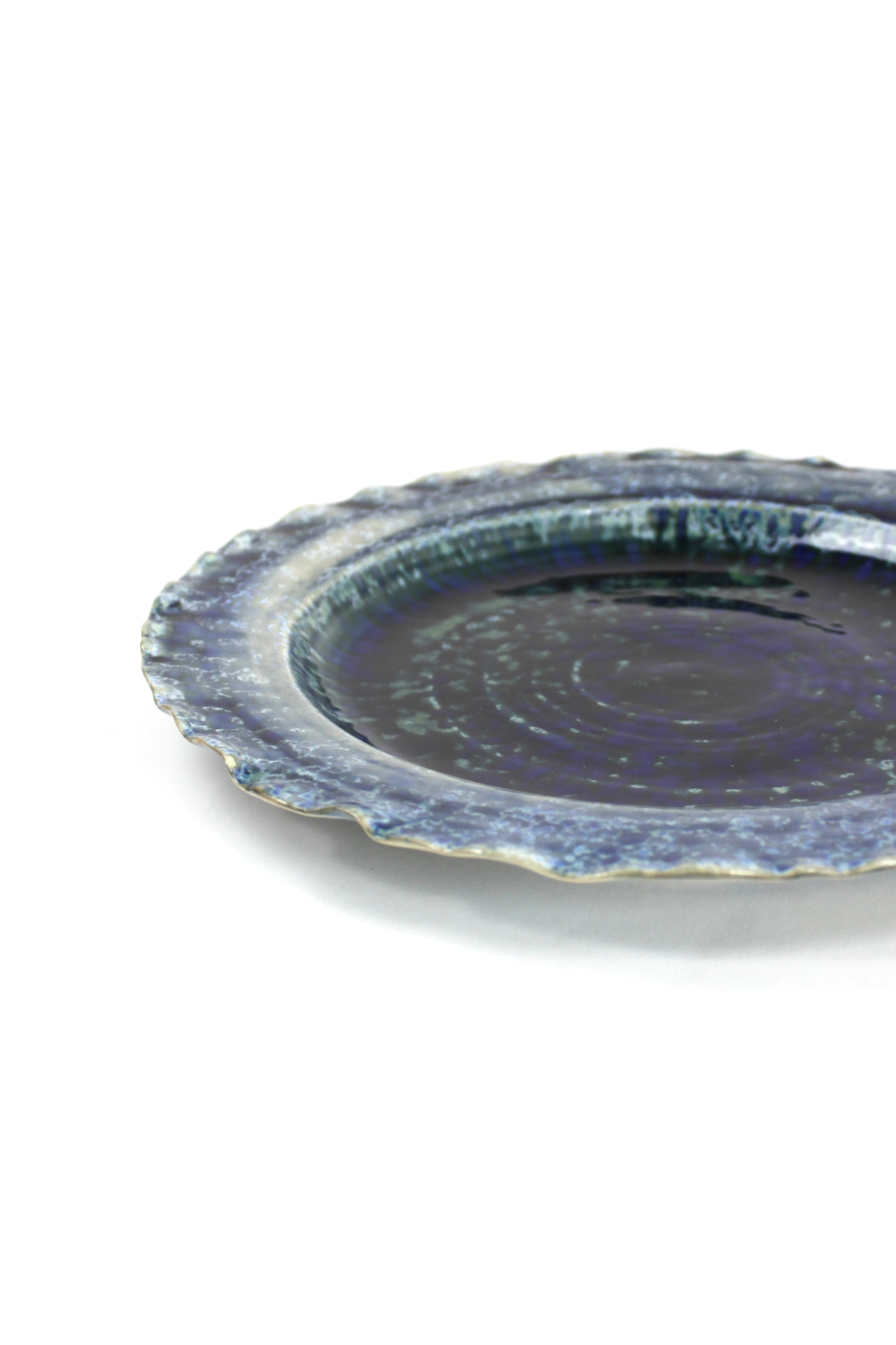 a glazed blue ceramic dinner plate from madcap cottage