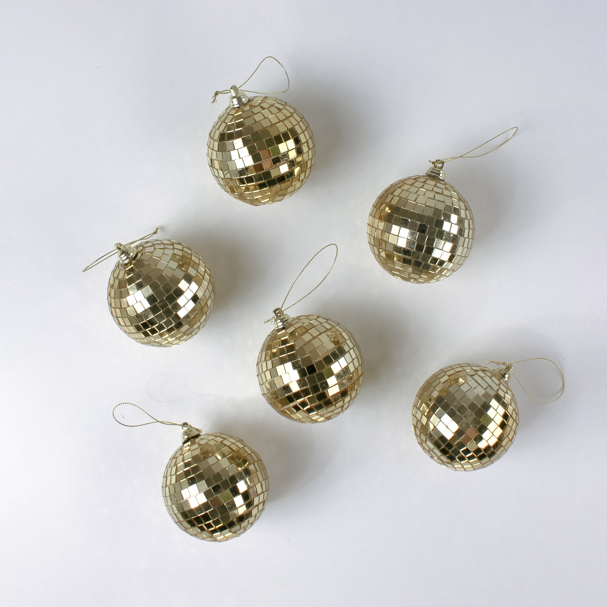 six mini gold disco ball ornaments on a white background