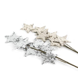 a silver spray of stars and gold spray of stars on a decorative branch. 