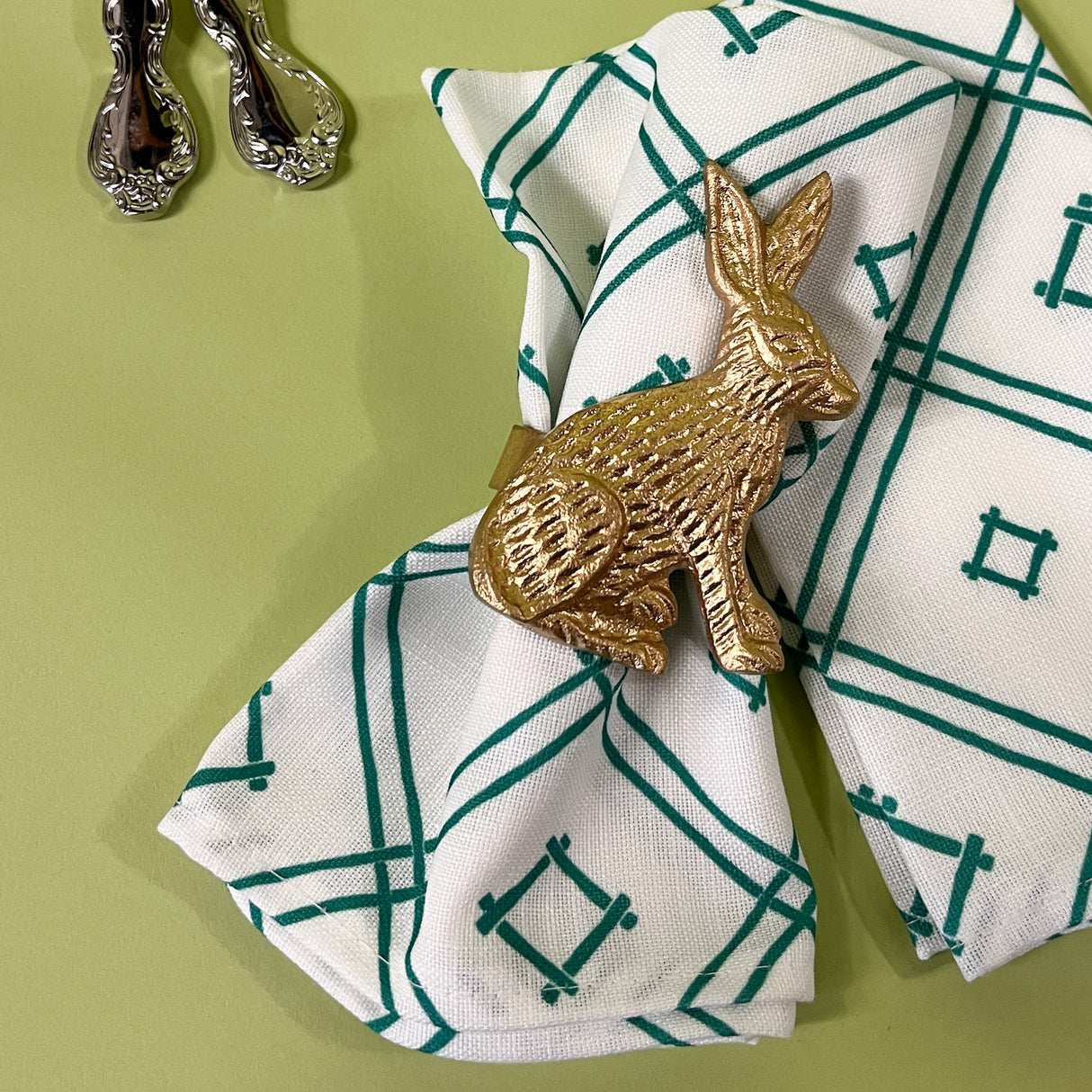 gilt metal bunny napkin ring on a napkin