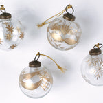 Set of 4 clear glass Christmas ornaments with elegant gold leaf and star designs, featuring gold hanging cords — perfect for adding a touch of luxury to holiday décor.