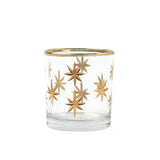 Clear glass candle holder with gold star designs on a white background