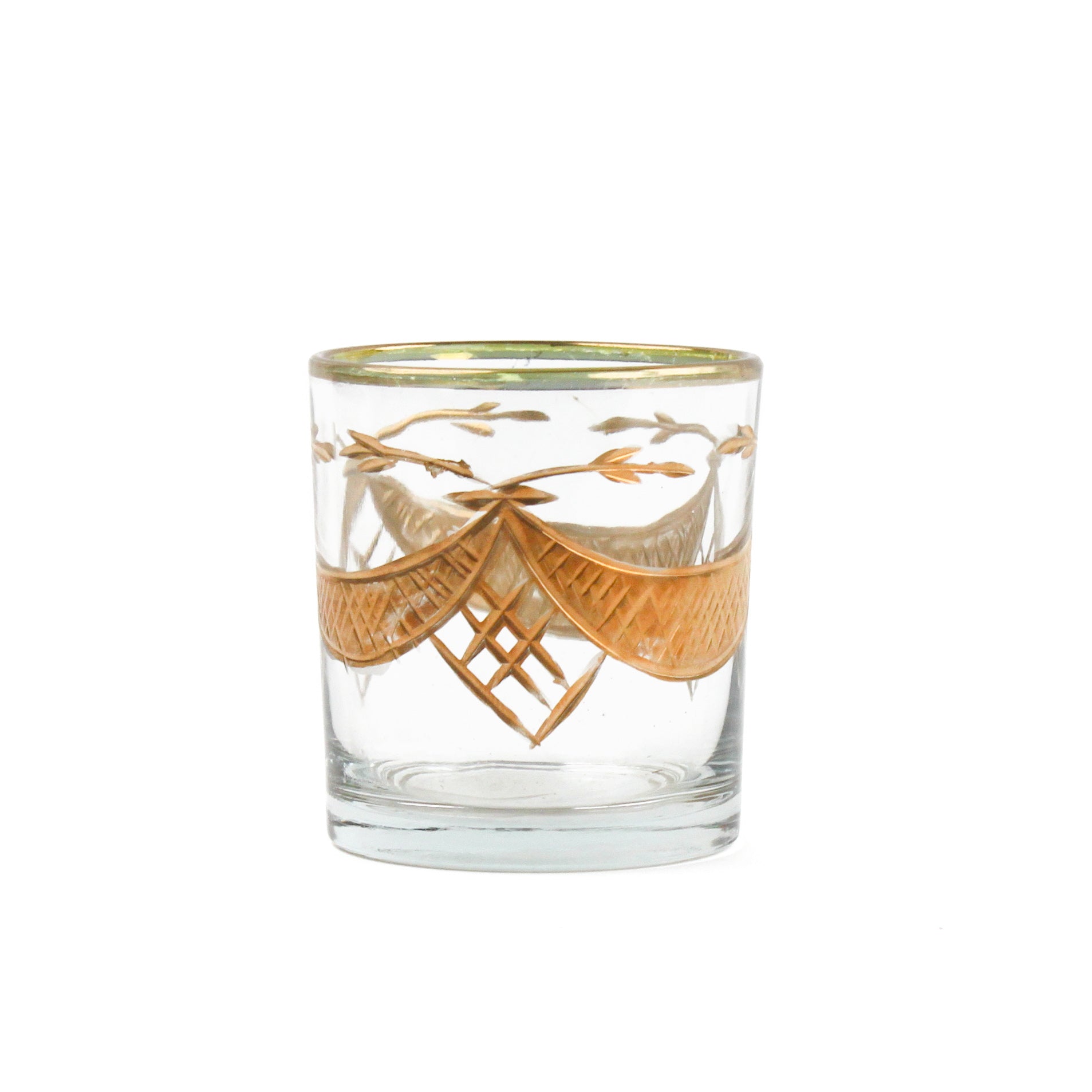 clear glass candle holder with a gold swag motif against a white background. 