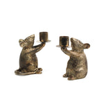 Two gold mouse candle holders on a white background