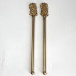 a pair of gold pineapple swizzle sticks from madcap cottage
